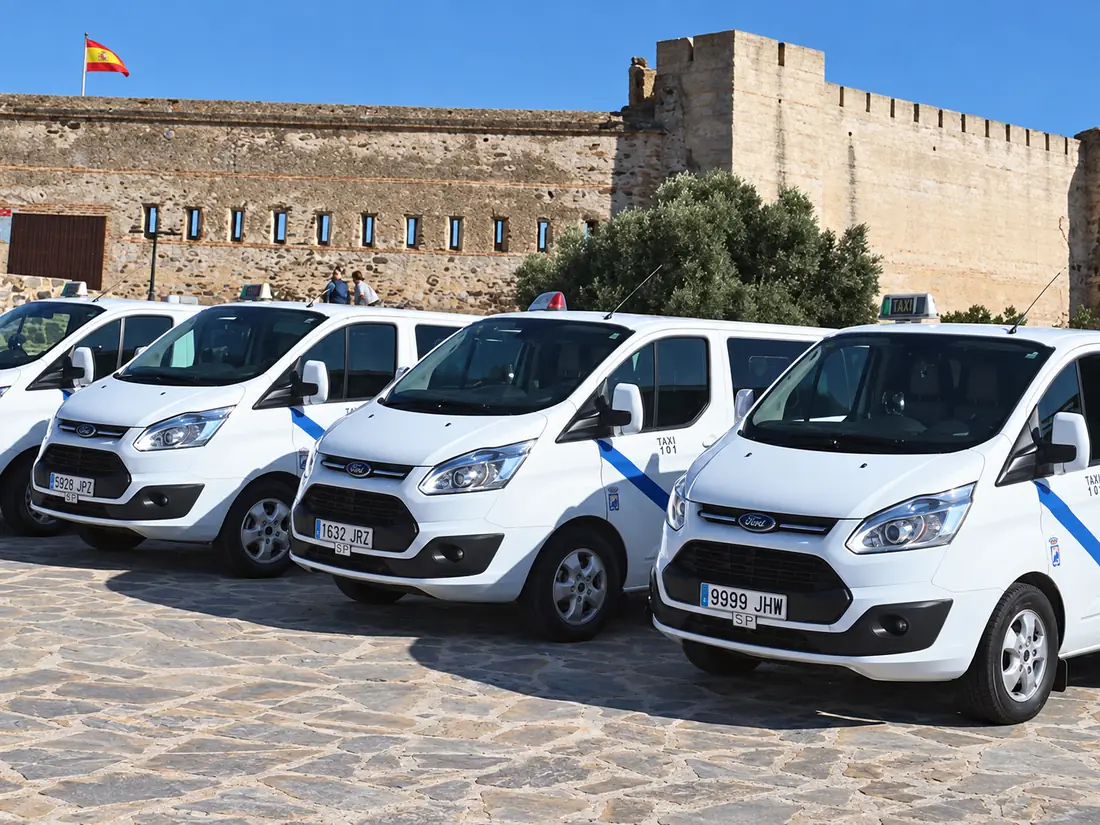 Taxi Grande Málaga fleet of large taxis beside a castle on the Costa del Sol