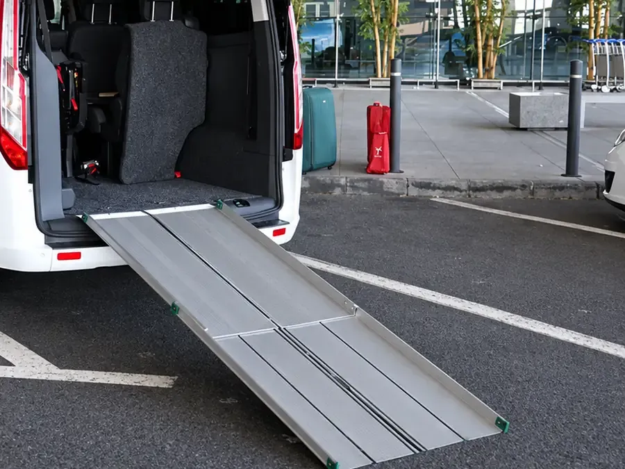 Taxi adaptado con la rampa desplegada frente a la terminal del aeropuerto de Málaga